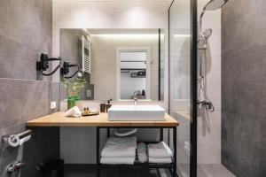 a bathroom with a sink and a shower at Evapollo in Thessaloniki