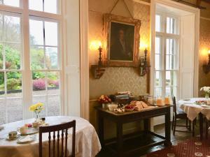 a dining room with two tables and a picture on the wall at The Castle in Castlehaven