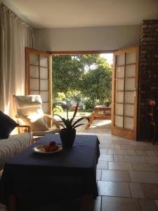 a living room with a table with a plate of fruit on it at Ocean Melody in Swakopmund