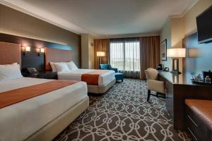 a hotel room with two beds and a desk at Argosy Casino Hotel & Spa in Kansas City
