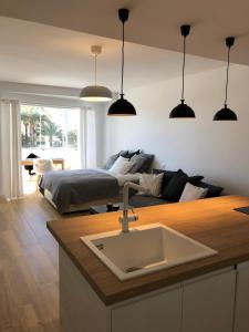 a kitchen with a sink and a bed in a room at Holiday Studio by Meatina in Torremolinos