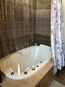 a white bath tub in a bathroom at Mowat Landing Cottages in New Liskeard +33 photos