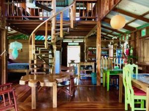 a room with a table and a spiral staircase at Las Ranitas in Puerto Viejo +23 photos