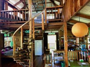 a wooden staircase in a room with a table at Las Ranitas in Puerto Viejo