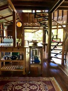 a kitchen with a stove in a room with wooden floors at Las Ranitas in Puerto Viejo