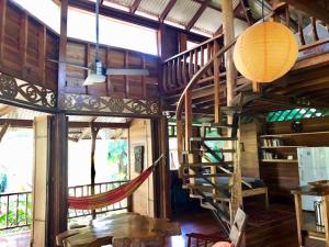 a room with a spiral staircase in a house at Las Ranitas in Puerto Viejo