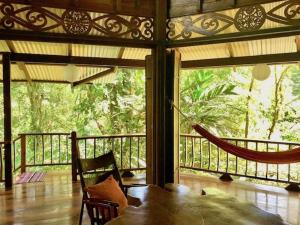 a room with a hammock on a screened in porch at Las Ranitas in Puerto Viejo
