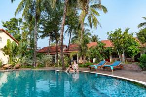 a man is playing in a swimming pool at Hula Hula Seafront Phu Quoc in Phu Quoc