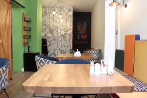a dining room with a wooden table and chairs at The Blue Bottle Central in Thessaloniki