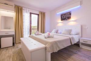 Postel nebo postele na pokoji v ubytování Apartments Family Roso