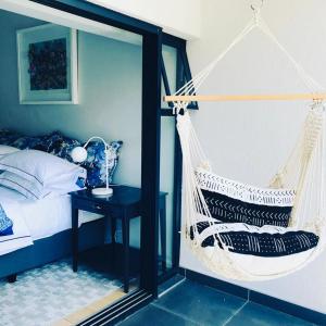 a bedroom with a hammock and a bed at Heart of the Cape.. in Cape Town