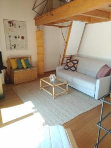 a living room with a couch and a table at CASA VISTA LAGO E GIARDINO in Porlezza