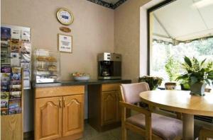 a kitchen with a table and a table and a counter top at Cabarrus Inn in Concord