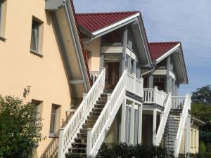 a building with white stairs and a red roof at FeWo an der Ostsee Nr. 1 in Rerik