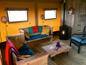 a living room with a couch and a table at Aan het Diepje in Lettelbert