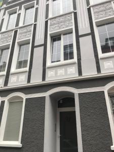 a black and white building with a door at Deluxe Wohnungen Dortmund Mitte in Dortmund