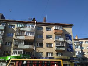 a building with a double decker bus in front of it at Elena in Rivne