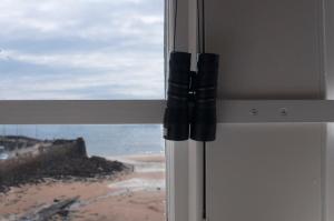 a window with a view of a beach at Murray Library Hostel in Anstruther