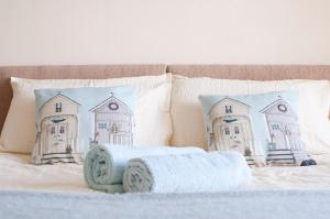 a bed with two pillows and a towel on it at Murray Library Hostel in Anstruther