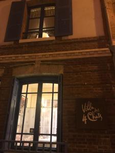 a building with a window and a sign on it at La maison des 4 chats in Trouville-sur-Mer