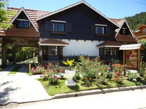 a house with a flower garden in front of it at Apart Rose Garden in San Martín de los Andes