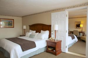 a hotel room with two beds and a telephone at Holiday Hill Inn & Suites in Dennis Port