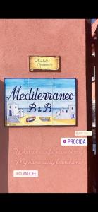 a sign for a restaurant on the side of a building at B&B Mediterraneo in Procida