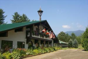 a building with flags on the side of it at Northern Lights Lodge in Stowe