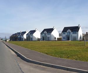 a row of houses on the side of a road at No 5 sandycove in Donegal