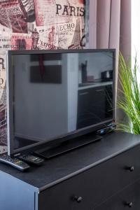 a large flat screen tv sitting on top of a dresser at King Beautique Resort in Budapest