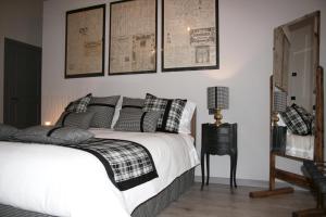 a bedroom with a bed and some pictures on the wall at B&B Rocambola in Nogara
