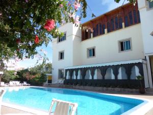 a swimming pool in front of a building at Riad Zahra in Essaouira