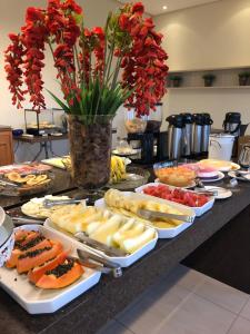a buffet with many different types of food on a table at Cast Comfort Hotel in Paranaíba