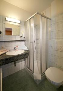 a bathroom with a shower and a sink and a toilet at Lärchenhof in Flachau
