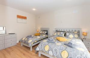 a bedroom with a bed and a dresser at The Arch Accommodation in Carrick-on-Suir