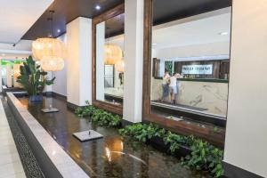 a lobby with a fish pond in the middle at Paradiso Resort by Kingscliff Accommodation in Kingscliff