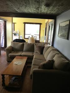 a living room with a couch and a coffee table at Mowat Landing Cottages in New Liskeard