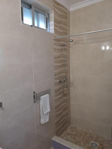 a bathroom with a shower with a glass door at Casa João Bravo in Albufeira