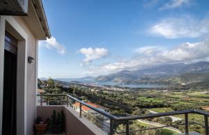 a balcony with a view of a city and a lake at Nikol apartment in Argostoli