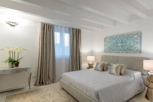 a bedroom with a bed and a large window at Villa Bianca Luxury Apartments in Desenzano del Garda +42 photos