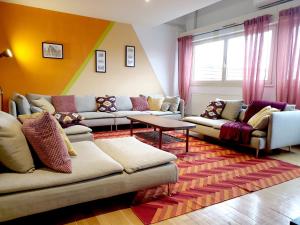 Una sala de estar con sofás y una mesa. en ColmarAppart Vauban, en Colmar