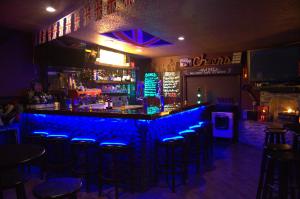 a bar with blue lights in a bar with stools at Redwoods River Resort & Campground in Leggett