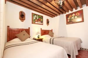 Postel nebo postele na pokoji v ubytování Hotel Mesón del Rosario