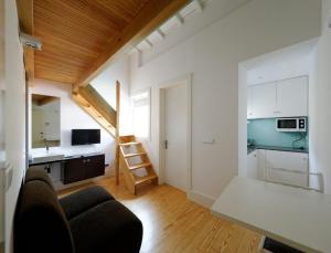 a small apartment with a staircase and a kitchen at Guimarães Studios Lounge in Guimarães