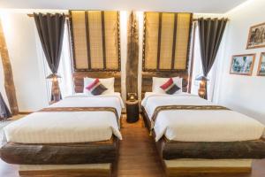 Giường trong phòng chung tại Khmer Paradise Villa