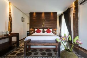 Giường trong phòng chung tại Khmer Paradise Villa