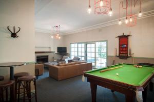 a living room filled with furniture and a pool at Oscar's On The Yarra in Warburton