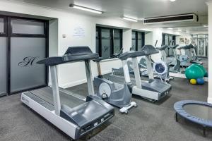 a gym with treadmills and elliptical machines at CityLife Auckland in Auckland