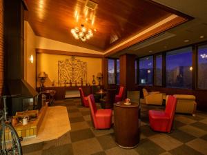 a lobby with a waiting room with red chairs at HAKONE GORA ONSEN Hotel Kasansui in Hakone