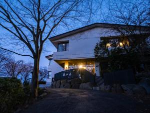 a house lit up at night with lights at HAKONE GORA ONSEN Hotel Kasansui in Hakone